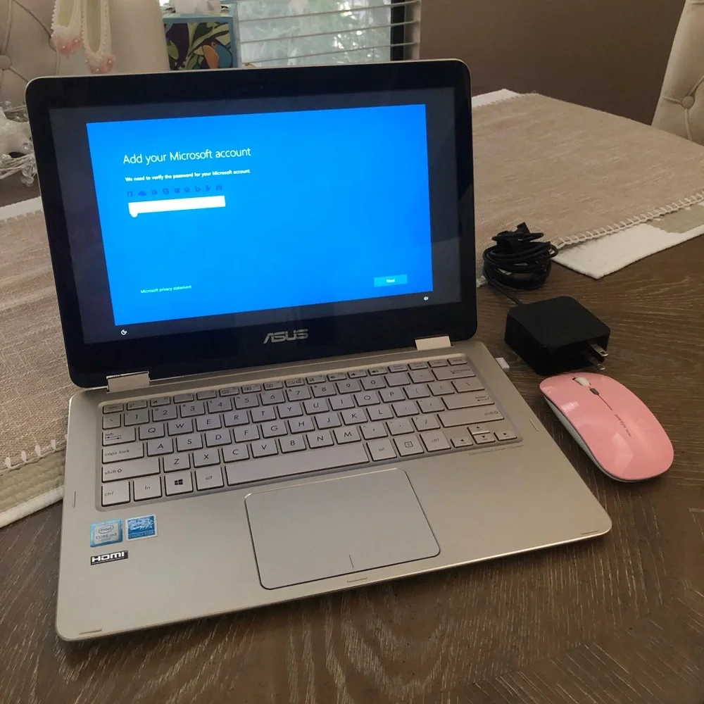 ASUS Metallic Silver Convertible Laptop with a wireless mouse and a charger.